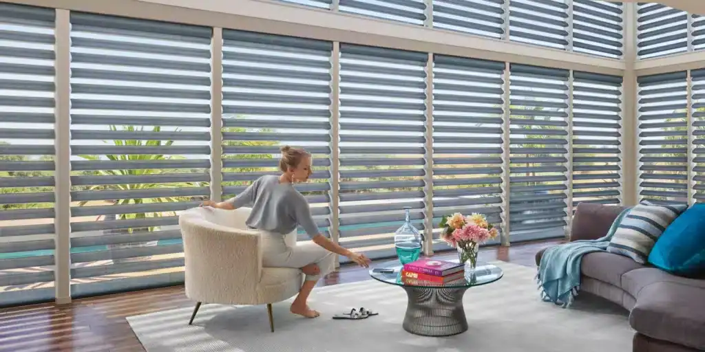 Modern custom horizontal metal blinds providing sleek window coverage in a bright living room with natural light.