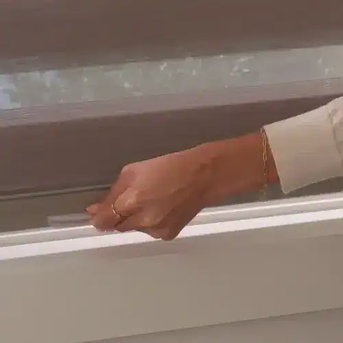 Sliding glass door with sleek white and brown window blinds, showcasing quality window treatment options.