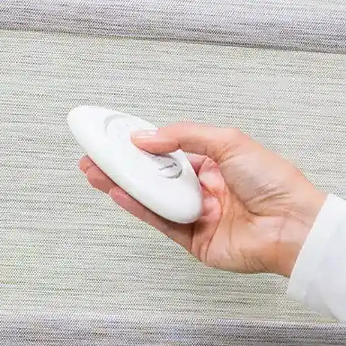 Flexible, white remote control device for window blinds, designed for easy adjustment and operation of window coverings, enhancing convenience in home or office settings.