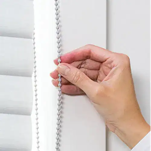 Adjustable white window blinds chain for easy light control and privacy.