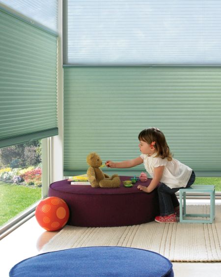 Soft green custom window blinds for children's rooms, enhance privacy and control light with superior blinds. Perfect for nursery and playroom window coverings.