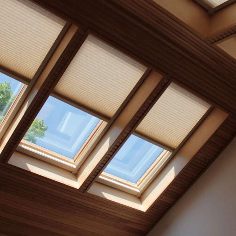 Luxurious skylight blinds with wooden trim for enhanced home decor and light control.
