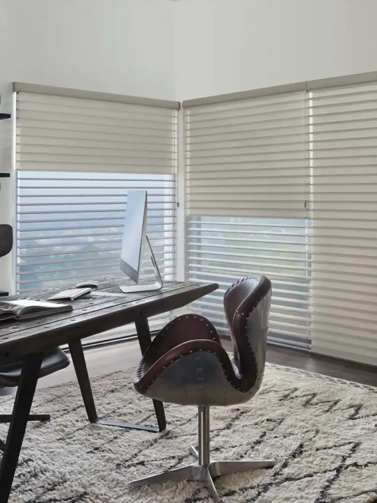 Modern white horizontal window blinds on office windows, offering light control and privacy. Perfect for home or workspace, enhancing decor and functionality with elegant, easy-to-operate window coverings.