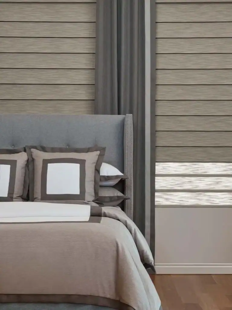 Elegant window blinds and curtains with a modern bedroom setting, showcasing superior custom window treatments for home decor and light control.
