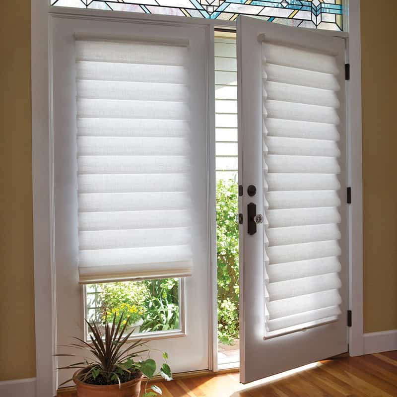 Light-blocking white cellular blinds on a glass door, designed for privacy and heat control. Perfect for enhancing home comfort while maintaining style and natural light.