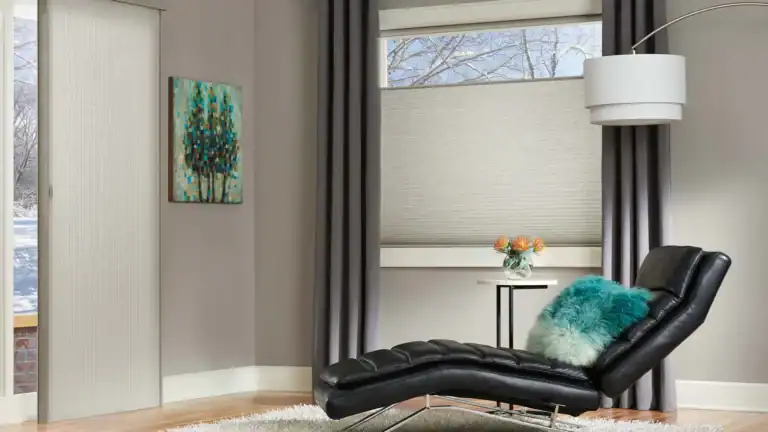 Light-filtering beige window shades with dark gray drapes in a modern living room setting.