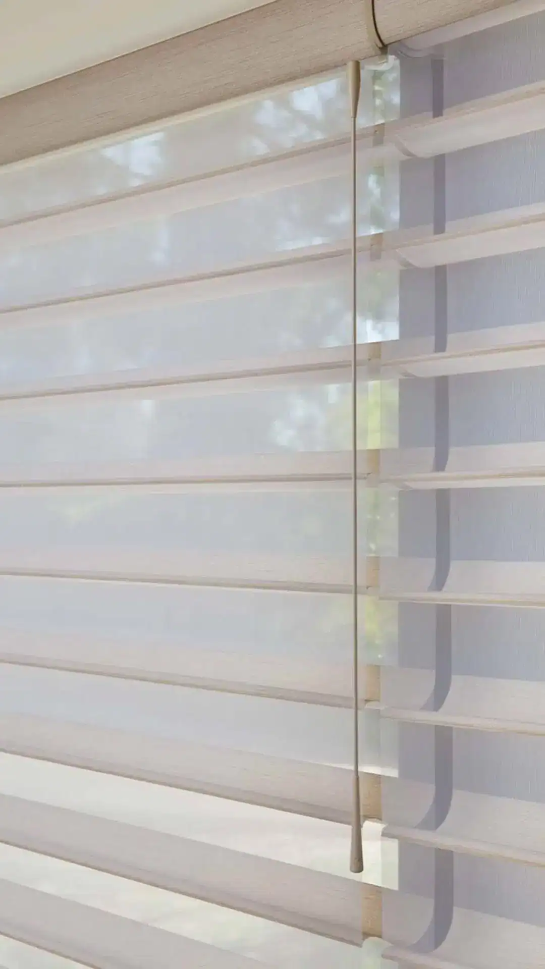 Light-filtering white custom window blinds with a pull cord, providing excellent privacy and light control for home or office spaces. Perfect for sleek, modern window treatments.
