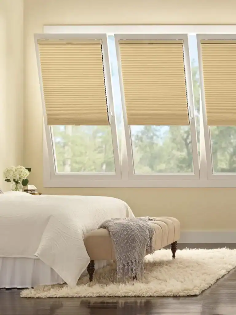 Smooth beige window blinds in a cozy bedroom with white walls and classic furniture, showcasing stylish and functional window treatment solutions by Superior Blinds.