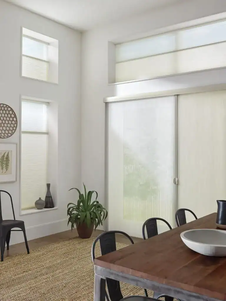Soft white window blinds installed in a modern dining room with natural light, complementing the minimalist decor and cozy atmosphere.