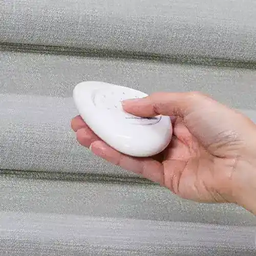 Soft white remote control for smart blinds, modern and sleek design.
