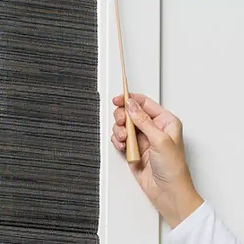 Smooth brown roller blind being installed on a window, showcasing premium window covering solutions by Superior Blinds.