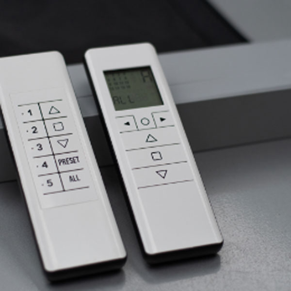 Two handheld remote controls for motorized shades