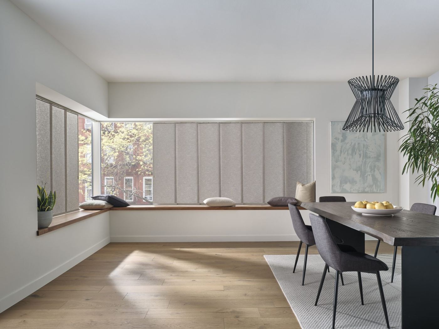 Hunter Douglas Skyline® Gliding Window Panels across a wide window in a modern dining room